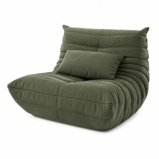 Fauteuil en tissu vert avec coussin